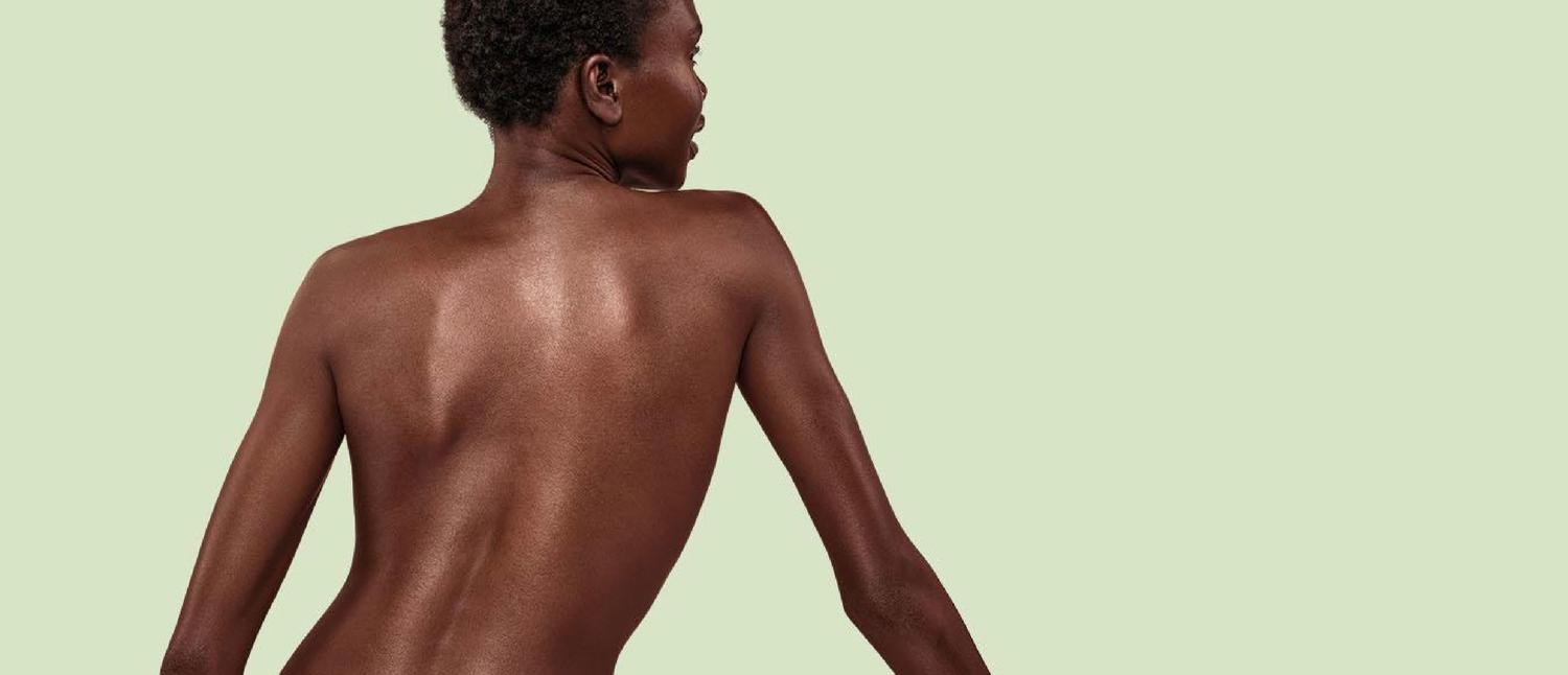 Woman standing with bare back showing